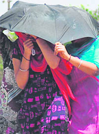Young girls try to cover themselves on a hot afternoon in Ludhiana on Saturday.