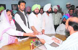 Congress candidate Sukhwinder Singh Danny (second from left) files nomination papers at Faridkot on Saturday. Rajinder Kaur Bhattal and Capt Amarinder Singh are also in the picture