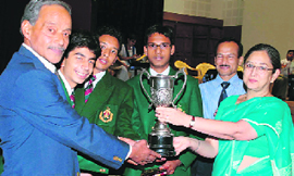 Students of Sherwood College receive the RIMC All-India Inter-School Challenge Quiz trophy from Welham School principal Jyotsna Brar in Dehradun.