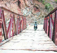 a dilapidated old wooden bridge near Sahiya on the Dehradun-Chakrata road.
