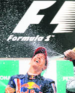 Red Bull Formula One driver Sebastian Vettel of Germany celebrates with Brawn GP Formula One driver Jenson Button of Britain after winning the Chinese F1 Grand Prix in Shanghai on Sunday. 