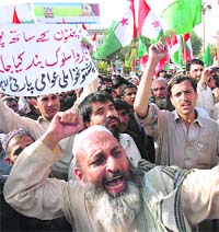 A man protests against alleged police raids on Pashtuns during a demonstration in Lahore on Sunday. 