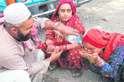 A Gujjar woman drinks water during the protest.