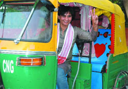 Sunita Chaudhry, the only woman auto driver in the city and candidate of the United Women's Front from New Delhi seat campaigns in New Delhi on Wednesday.