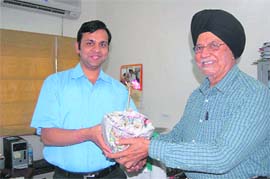 Saurabh Jain, additional secretary, power, Uttarakhand, gets a sapling from Swaran Singh, director and head of corporate affairs of a hydro-electric company at an Earth Day function in Dehradun