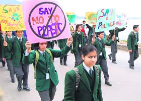 School students take out a march on World Earth Day near Dal Lake in Srinagar