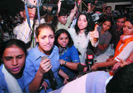 Akritis friends have a heated argument with the principal of the school during a press conference in New Delhi on Thursday.