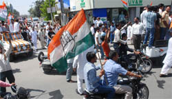 Supporters of Congress candidate Mohinder Singh Kaypee during the road show before the filing of nomination papers in Jalandhar on Thursday.