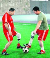Lebanese footballers wearing prosthetic limbs train with the Mine Survivors team in the southern city of Sidon.