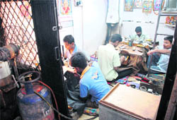 Artisans crafting jewellery in a cluttered shop of Sector 22-D, Chandigarh.