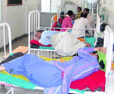 Attendants sleep on beds in childrens ward of Doon Hospital. 