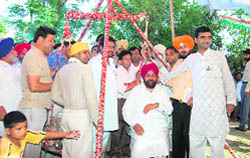 Congress candidate from Gurdaspur Pratap Singh Bajwa being weighed against coins at Behrampur village in Gurdaspur
