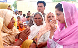 Harsimrat Badal listening to the problems of Goniana Khurd villagers during her poll campaign.