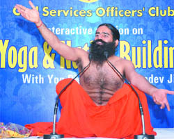 Swami Ramdev teaches yoga to members of the Civil Services Officers Club in New Delhi on Sunday. 