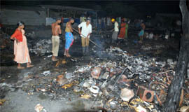 Firemen attend to jhuggies that caught fire at Sector-32 in Gurgaon on Saturday night.