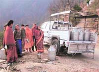 Canes of milk being unloaded in a hill village