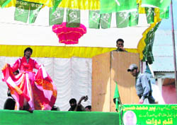 A man dressed as a woman performs on the stage to entertain Kashmiri voters in Kulgam
