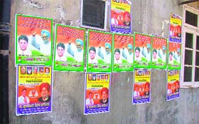 Posters of SAD and Congress candidates have been put on a wall in violation of the poll code in Ludhiana