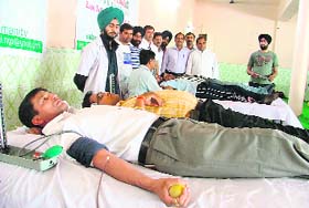 A volunteer donates blood at a blood donation camp organised by Salam Zindagi Foundation in Ludhiana