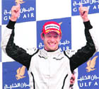 Brawn GP's British driver Jenson Button celebrates on the podium.