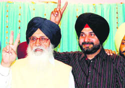 Chief Minister Parkash Singh Badal and Navjot Singh Sidhu show victory sign in Amritsar on Monday.