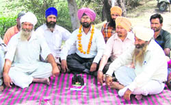 Jaspreet Singh (centre) sits on a dharna in Ropar on Monday.
