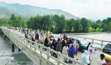 Local residents flee from a troubled area of Pakistans Lower Dir district, where troops launched an operation against militants on Monday. A radical cleric, acting as Talibans go-between in Pakistans restive Swat valley, broke off talks with the government on Monday after the offensive.
