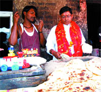 Bal Krishan, also an Independent candidate, is busy preparing chapatis at his dhaba in Amritsar.
