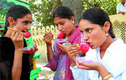 Girls relish burf ka gola near Company Bagh in Amritsar.