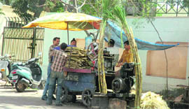 A vendor sells sugarcane juice in Jammu.