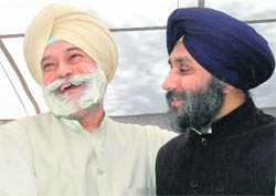 Bir Devinder Singh and SAD president Sukhbir Badal share a light moment after formers induction into the SAD at a function in Chandigarh on Tuesday.