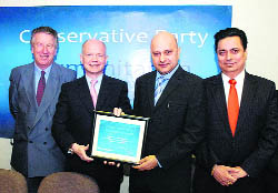 Leader of the Conservative Party William Hague  presents the Humanitarian Award to Kulwant Dhaliwal in the Parliament House in London.