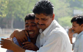 A man tries to console a relative of an accident victim