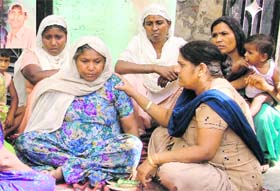 Neighbours consol Tarsem’s mother; (inset) Tarsem, who died while cleaning sewer in Mansa