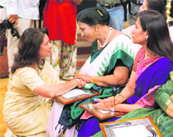 Actor Sharmila Tagore sharing a word with National President YWCA Nirmala Fenn (centre) as ICICI MD Chanda Kochhar looks on during the presentation of FICCI's Women of Excellence Awards in New Delhi
