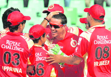 Royal Challengers Bangalore skipper Kevin Pietersen celebrates with teammates the wicket of Kolkata Knight Riders' skipper Brendon Mccllum. 