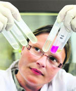 Assitant agrarian technician Katja Meindl poses with some human saliva samples during the analysis for swine flu virus at an institute in Oberschleissheim near Munich, southern Germany, on Wednesday.