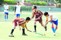 Players slug it out during a match between Welhams Boys and St Georges, Mussoorie,