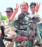 Independent candidate Naresh Singh Bhadoria canvasses wearing garland of shoes, apparently to show real face of politicians indulging in corruption, in Amritsar.