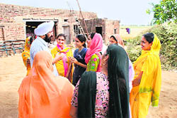 Baba Balkar Singh with a group of rural women.