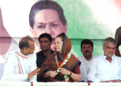 Congress president Sonia Gandhi addressing a rally in Sriganganagar on Friday. She was flanked by Rajasthan CM Ashok Gehlot 