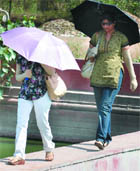 Girls try to beat the heat with umbrellas and gloves in New Delhi on Friday.