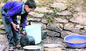 A boy at a dhaba in Chamoli washes utensils.