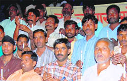 Small vendors take out a candle march to remember martyrs on Labour Day. 