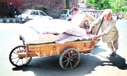 Performing the normal grind to earn his daily meals on May Day in Jammu on Friday.