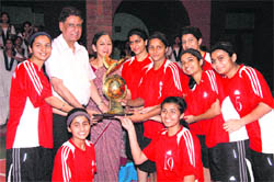 The winning team from Welhams Girls with the trophy in Dehradun on Saturday.