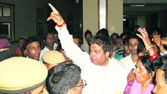 Surender Kaku, a former Congress MLA, raising slogans against the administration during a protest in the Dr R P Government College and Hospital, Tanda, on Friday evening following the death of two school children.