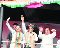 AICC president Sonia Gandhi with Dhani Ram Shandil (centre) and PCC president Kaul Singh Thakur waving to supporters at an election rally in Shimla on Saturday.