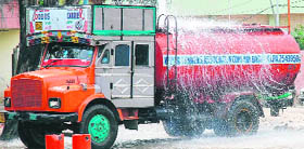 Drinking water overflows from a tanker at a water filling station in Jammu.