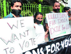 Kashmiri-Hindu migrants stage a silent protest to demand simplification of voting procedure for them, at Jantar Mantar in New Delhi on Sunday.